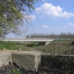 A vasúti Kapos-híd északi hídfőjéről nézünk át a 66-os főútvonal Kapos-hídjára